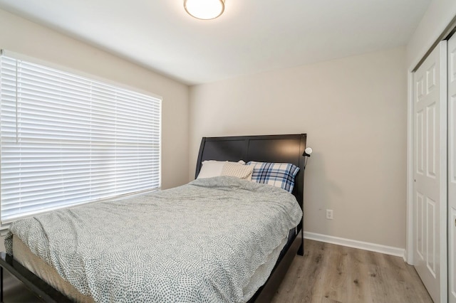 bedroom featuring a closet and light hardwood / wood-style flooring