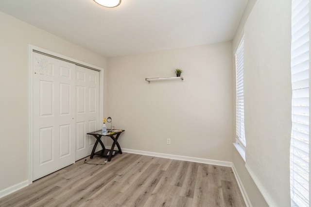 unfurnished bedroom with a closet and light hardwood / wood-style flooring