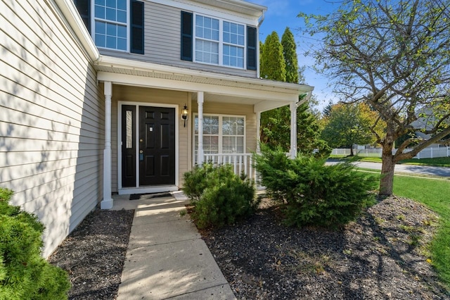 property entrance featuring a porch