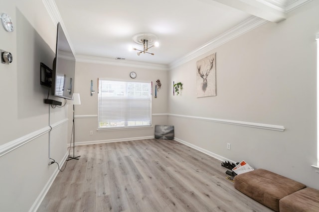 interior space with an inviting chandelier, ornamental molding, and light hardwood / wood-style flooring