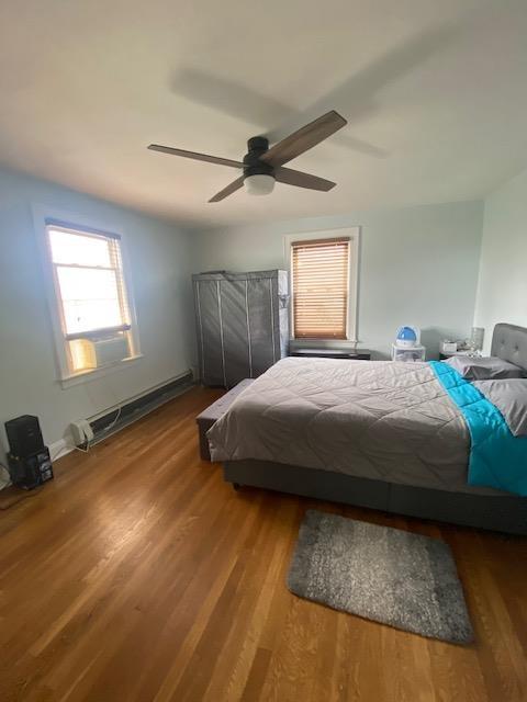 6 Stone Ave, Elmwood Park, NJ 07407 - bedroom featuring baseboard heating, wood finished floors, and ceiling fan