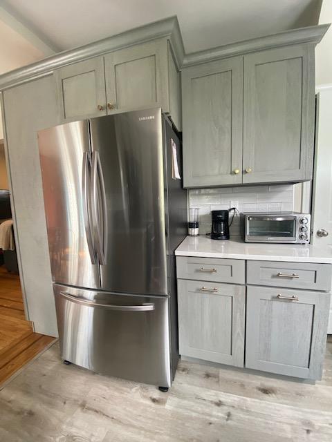 6 Stone Ave, Elmwood Park, NJ 07407 - kitchen with freestanding refrigerator, gray cabinets, light countertops, and light wood-style floors