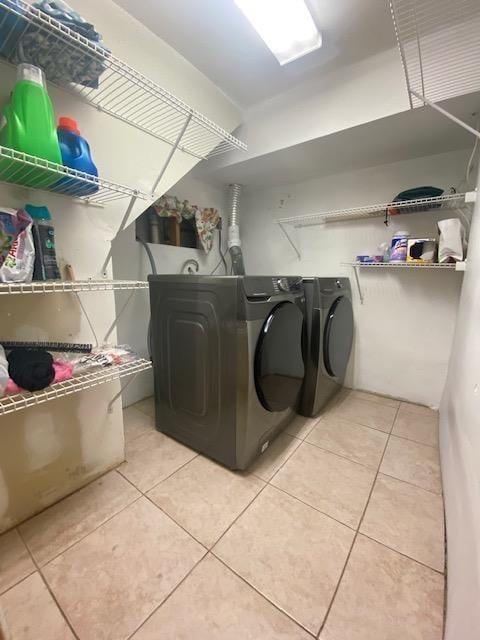 6 Stone Ave, Elmwood Park, NJ 07407 - laundry area with light tile patterned flooring and washer and clothes dryer