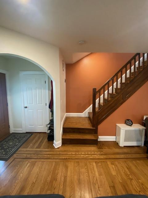 6 Stone Ave, Elmwood Park, NJ 07407 - stairway with wood finished floors and arched walkways