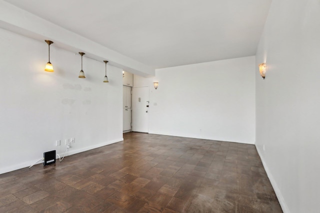 unfurnished living room with baseboards