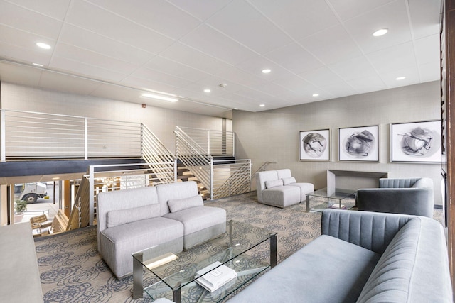 living room featuring stairway, carpet flooring, recessed lighting, and a paneled ceiling
