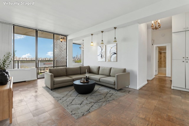 living room with an inviting chandelier and a water view