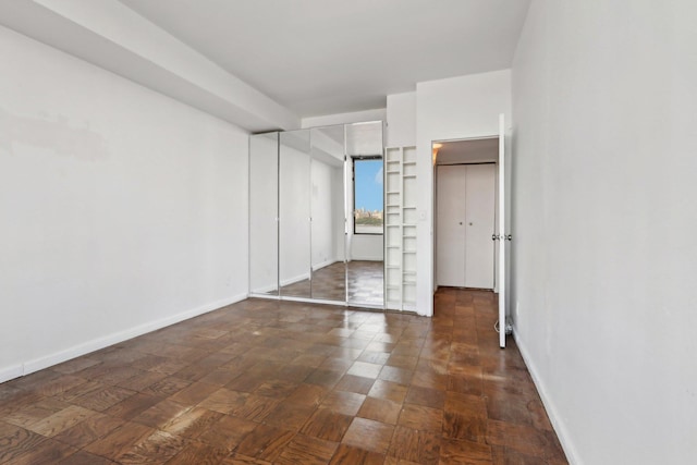 unfurnished bedroom with baseboards