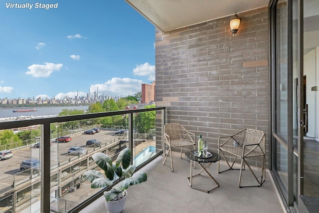 balcony with a city view and a water view