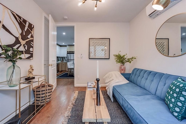 living room with hardwood / wood-style floors and a wall mounted air conditioner