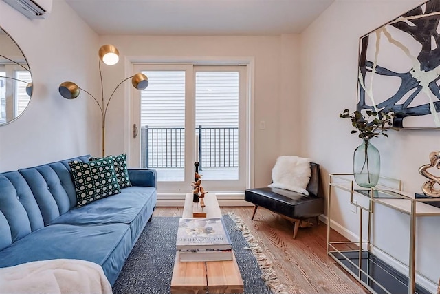 living room featuring a wall unit AC and hardwood / wood-style floors