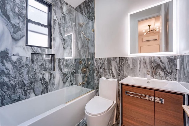 full bathroom featuring toilet, vanity, tile walls, a notable chandelier, and bathing tub / shower combination