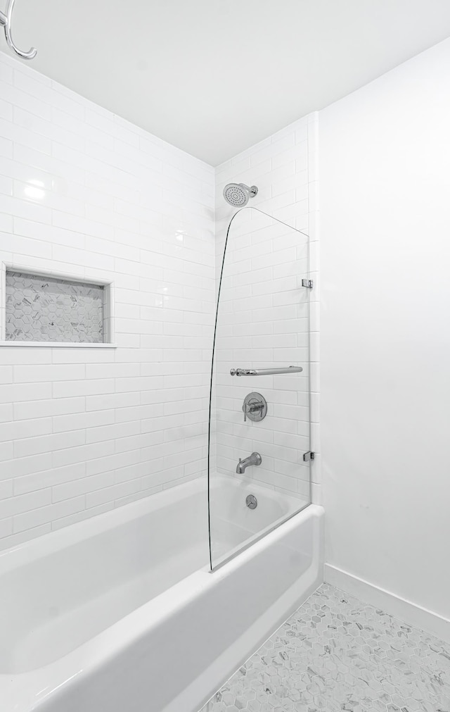 bathroom with tile patterned flooring and tiled shower / bath