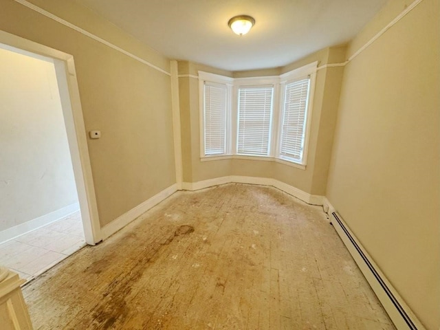 313 Pearsall Ave, Jersey City, NJ 07305 - empty room featuring a baseboard radiator and baseboards