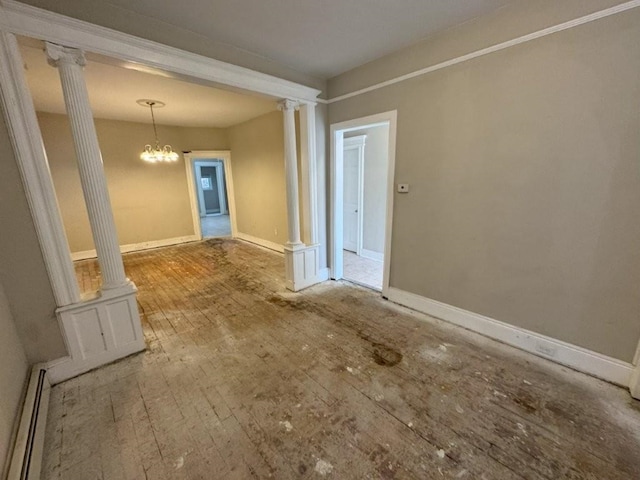 313 Pearsall Ave, Jersey City, NJ 07305 - spare room with decorative columns, a baseboard heating unit, wood-type flooring, and a chandelier