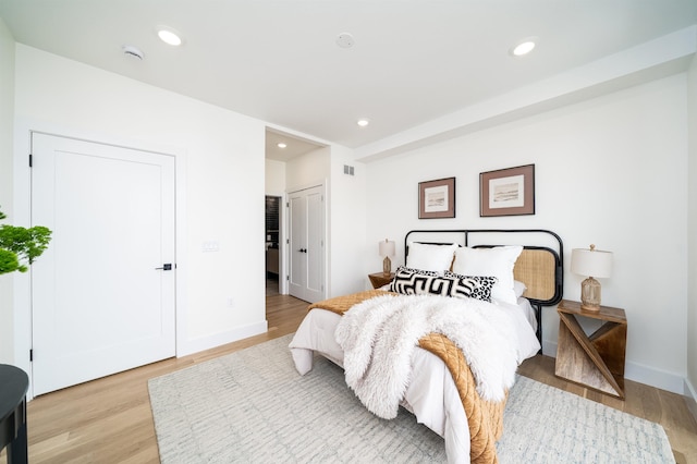 bedroom with recessed lighting and light wood-type flooring