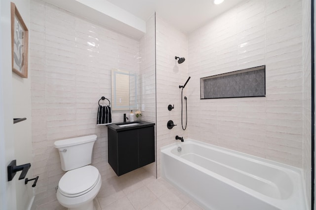 bathroom with toilet, tile walls, washtub / shower combination, tile patterned flooring, and vanity