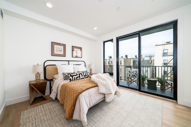 bedroom with recessed lighting, baseboards, light wood-style floors, and access to outside