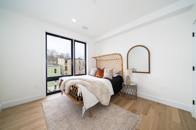 bedroom with visible vents, recessed lighting, light wood-style floors, and baseboards