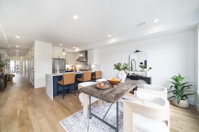 living area featuring light wood finished floors, visible vents, recessed lighting, and baseboards