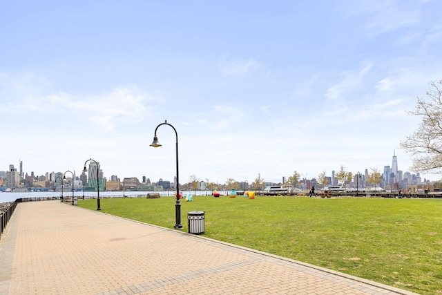 view of property's community with a view of skyline and a lawn