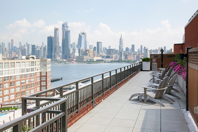 balcony featuring a view of skyline and a water view