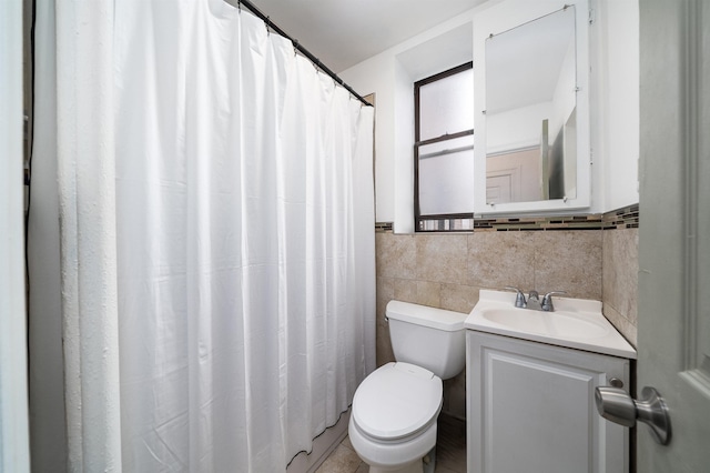 bathroom with tasteful backsplash, toilet, vanity, and tile walls