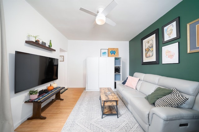 living room with light hardwood / wood-style floors and ceiling fan