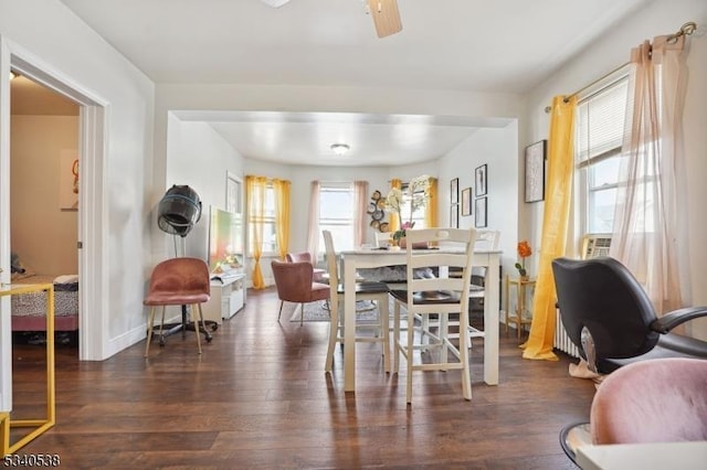 dining room with dark wood-style floors, baseboards, and a ceiling fan