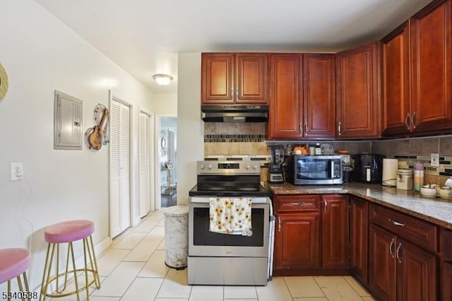 kitchen with stainless steel appliances, backsplash, dark stone countertops, electric panel, and under cabinet range hood