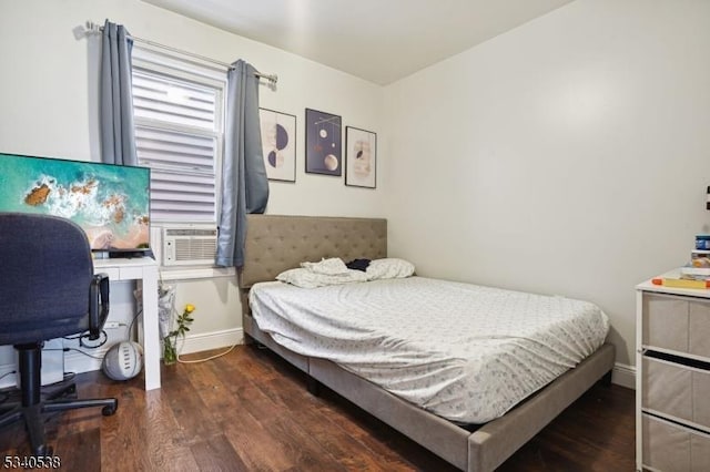 bedroom with dark wood-type flooring, cooling unit, and baseboards