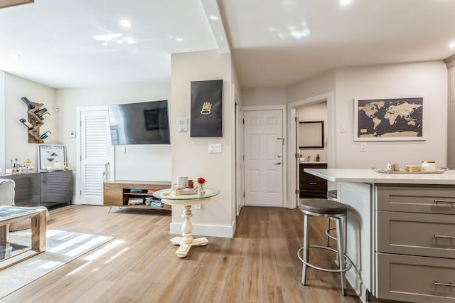 801 Willow Ave Unit 3R, Hoboken, NJ 07030 - kitchen featuring gray cabinetry, light countertops, light wood-style floors, baseboards, and a breakfast bar
