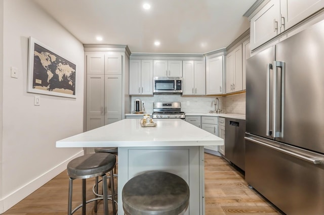 801 Willow Ave Unit 3R, Hoboken, NJ 07030 - kitchen featuring stainless steel appliances, a breakfast bar, a sink, light countertops, and backsplash