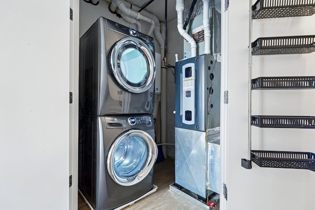 laundry room featuring stacked washer and clothes dryer and laundry area
