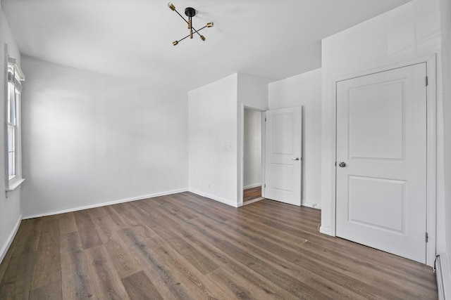 unfurnished bedroom featuring dark wood-style flooring and baseboards