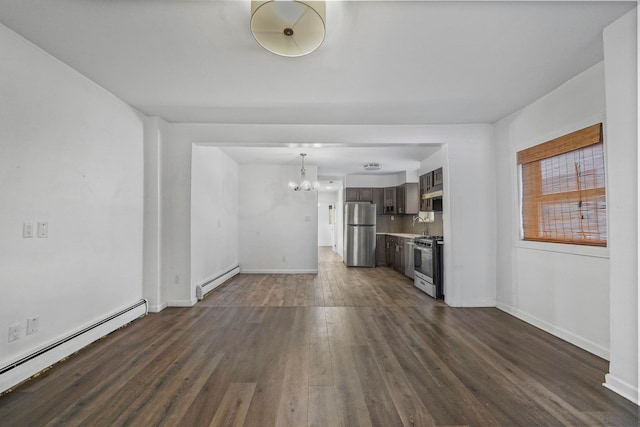 unfurnished living room with dark wood-style floors, a baseboard radiator, baseboards, and an inviting chandelier