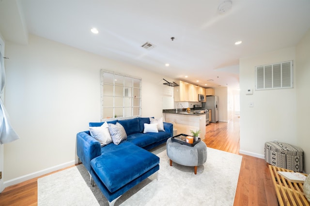 221 Clinton St Unit 3R, Hoboken, NJ 07030 - living room featuring light wood-style flooring, baseboards, and recessed lighting