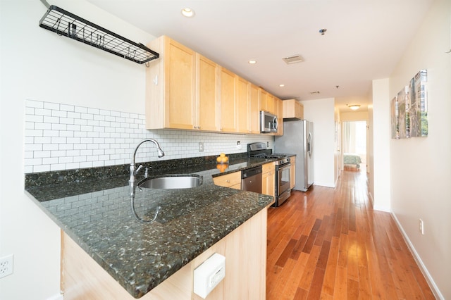 221 Clinton St Unit 3R, Hoboken, NJ 07030 - kitchen featuring stainless steel appliances, light brown cabinetry, a sink, baseboards, and light wood finished floors