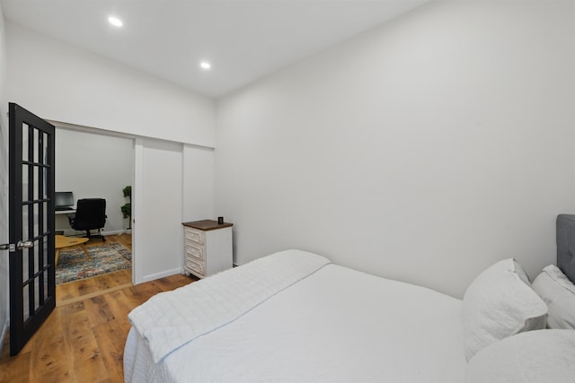 bedroom featuring recessed lighting and wood finished floors