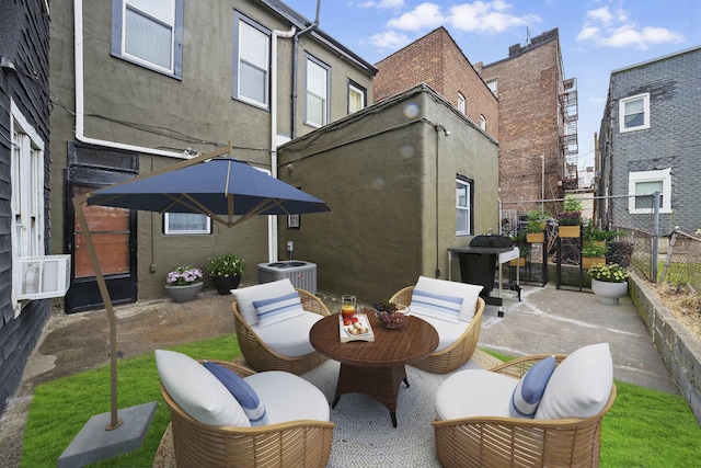 view of patio / terrace with central AC unit, a grill, fence, and outdoor dining area