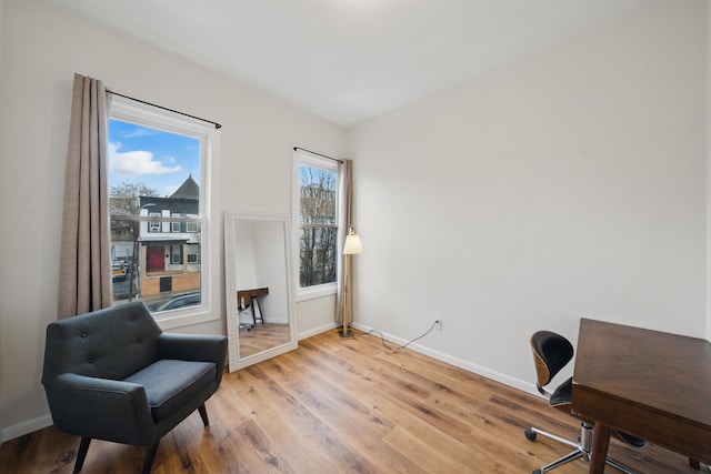 home office with baseboards and light wood-style floors