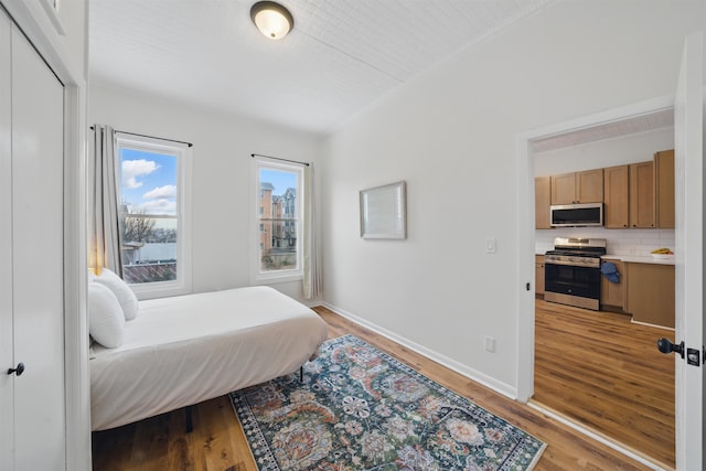 bedroom featuring baseboards and light wood finished floors