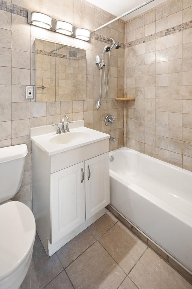 135 Montgomery St Unit 19A, Jersey City, NJ 07302 - bathroom with tile walls, shower / tub combination, vanity, and tile patterned flooring