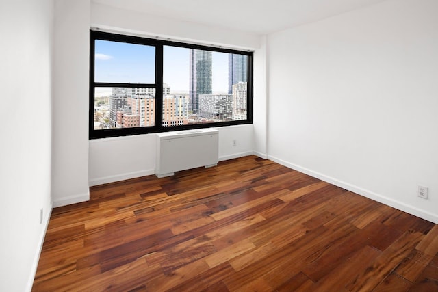 135 Montgomery St Unit 19A, Jersey City, NJ 07302 - spare room featuring wood finished floors, plenty of natural light, and a city view