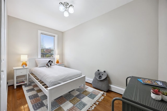 227 7th St, Jersey City, NJ 07302 - bedroom featuring baseboards, a baseboard radiator, wood finished floors, and baseboard heating