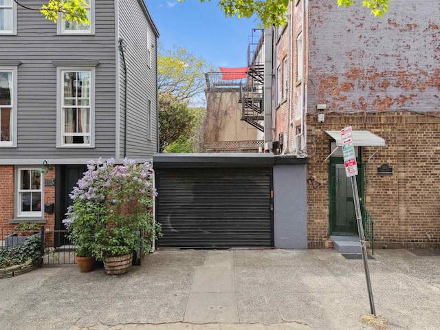 227 7th St, Jersey City, NJ 07302 - view of home's exterior featuring a gate, an attached carport, and brick siding