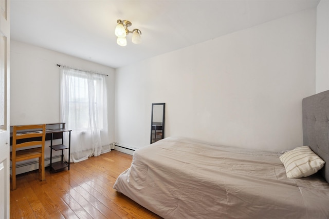 227 7th St, Jersey City, NJ 07302 - bedroom with a baseboard radiator and wood-type flooring