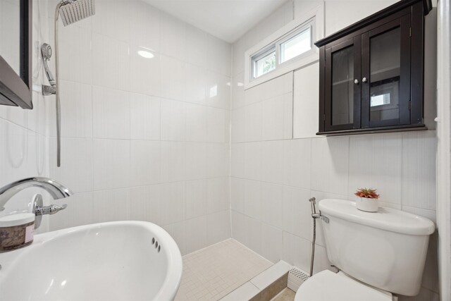 227 7th St, Jersey City, NJ 07302 - bathroom with toilet, a sink, tiled shower, and tile walls