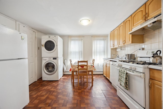 227 7th St, Jersey City, NJ 07302 - kitchen featuring white appliances, light countertops, stacked washing maching and dryer, decorative backsplash, and under cabinet range hood