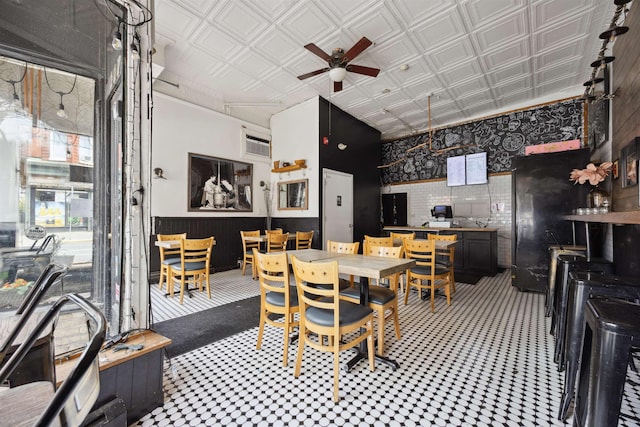227 7th St, Jersey City, NJ 07302 - dining room featuring tile patterned floors, wainscoting, ceiling fan, and an ornate ceiling